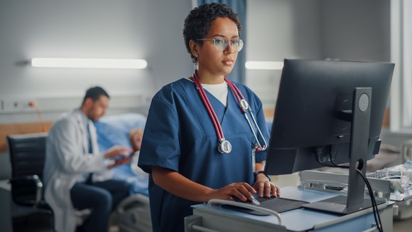 Person working in a hospital at a computer.