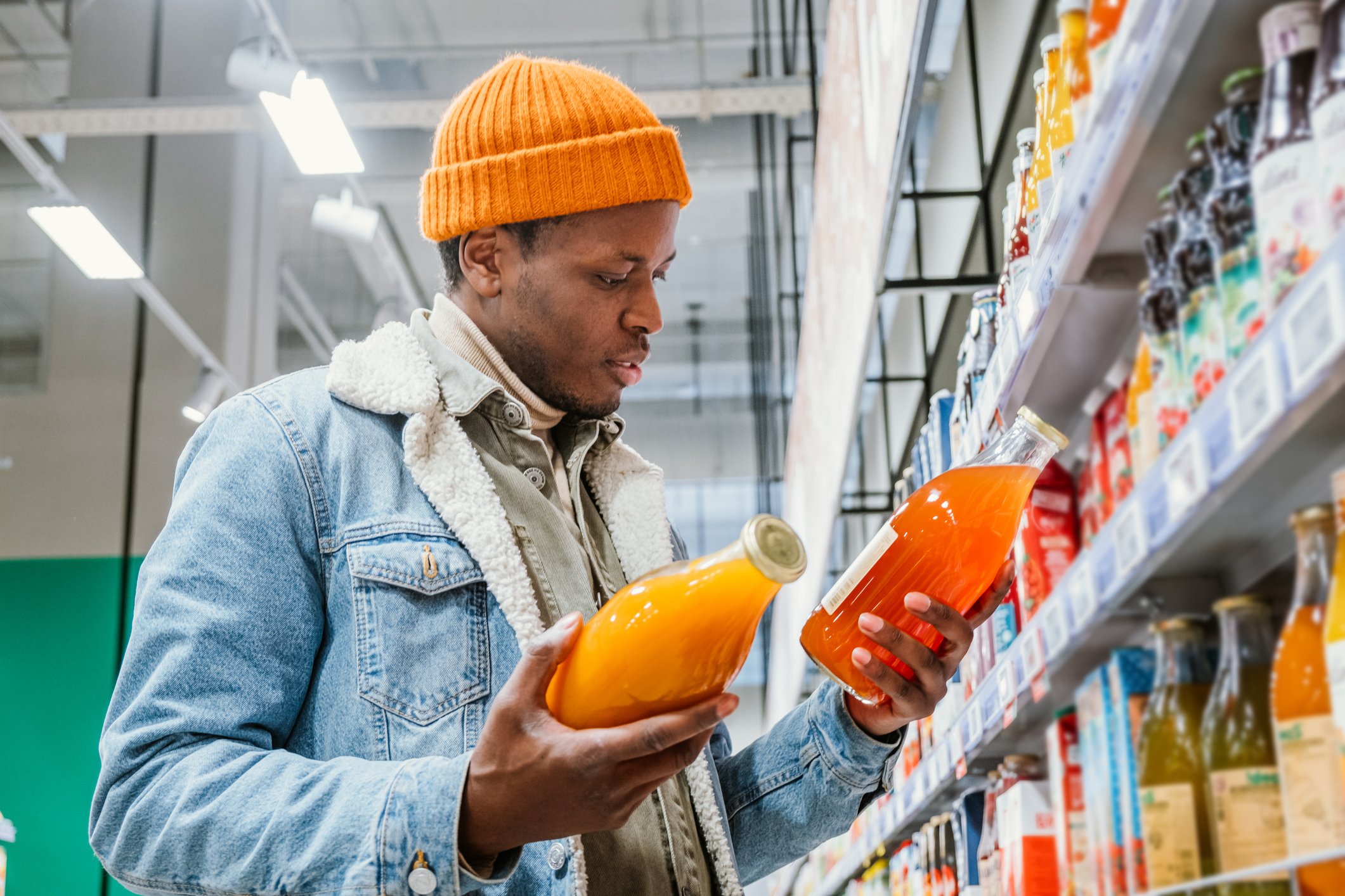 Shopper comparing food labels at the grocery store.
