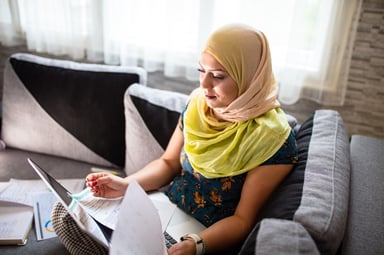 woman paper laptop working couch at home