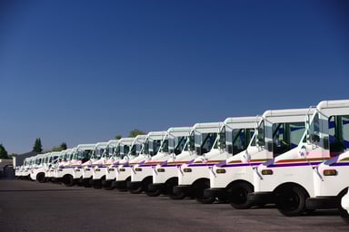 line of postal trucks