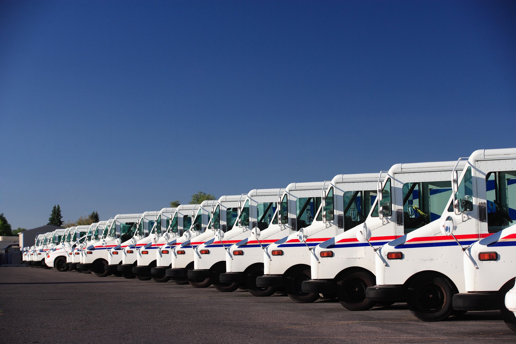line of postal trucks