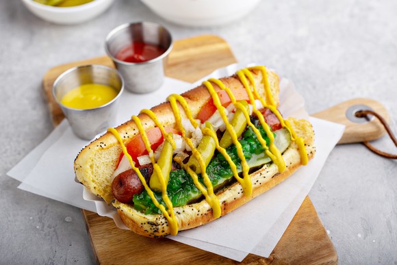 A hot dog dressed up with fixings. 