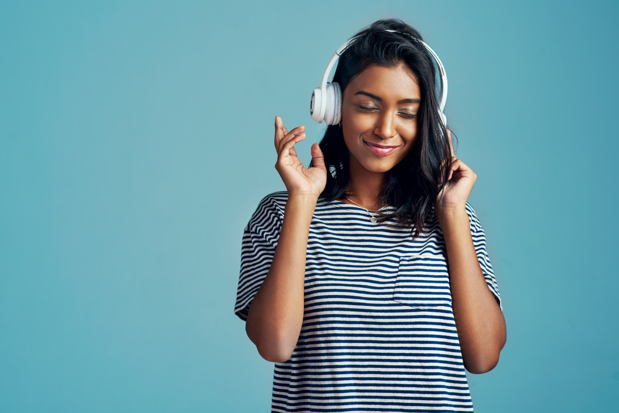 Person listening to music through headphones. 
