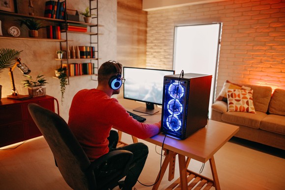 A gamer playing video games on a PC.