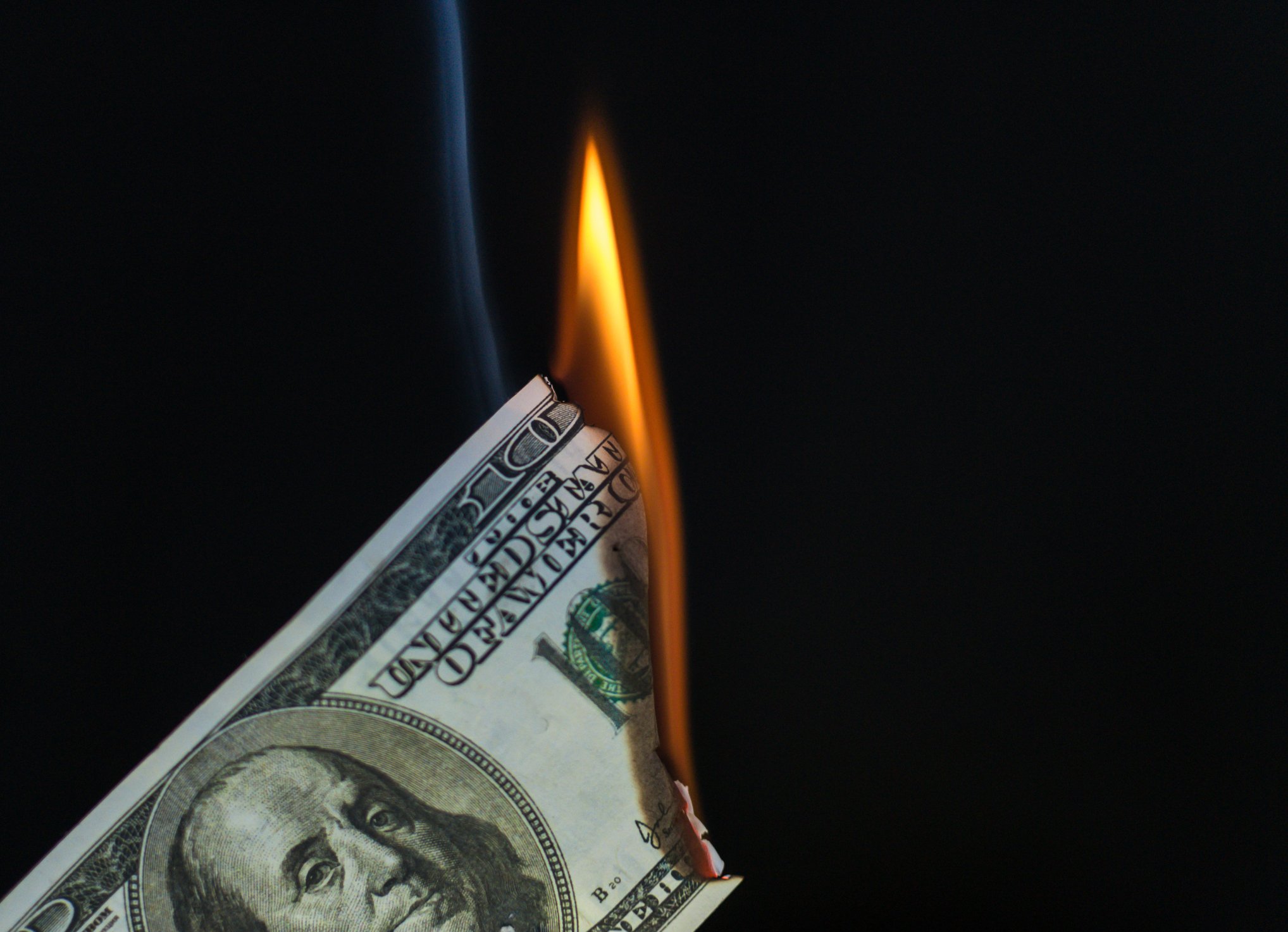 Hundred-dollar bill on fire.