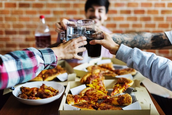 A group of friends eating pizza together.