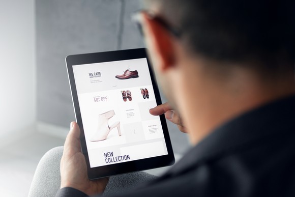 Person online shopping from a tablet device.