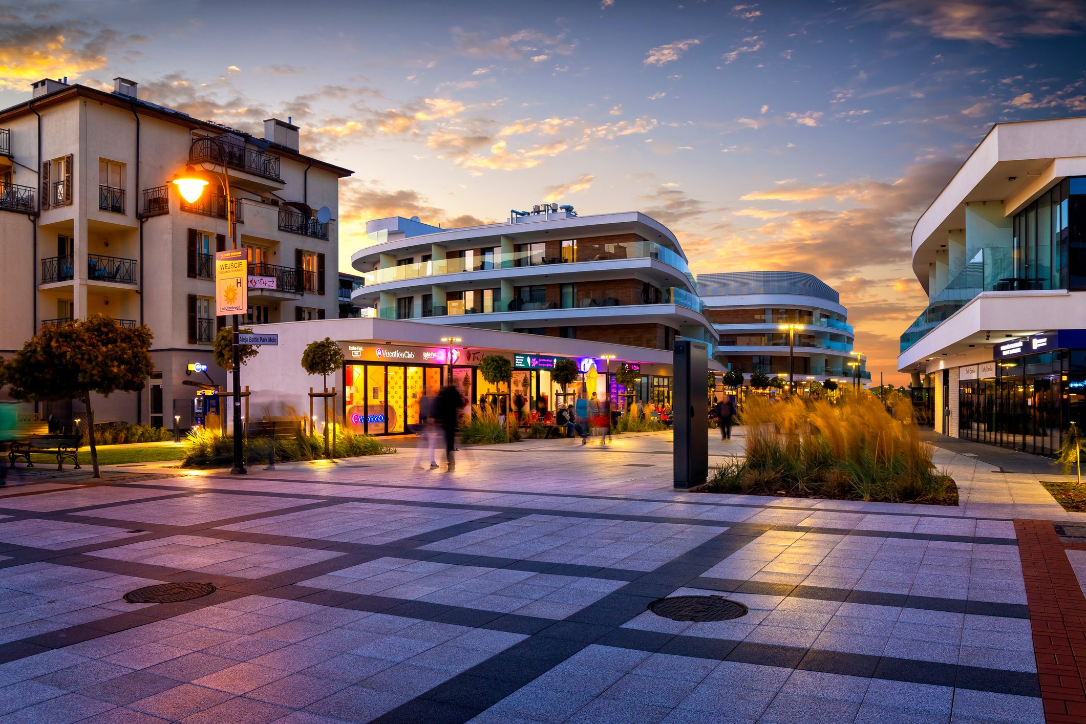 Apartment and retail properties at dusk.