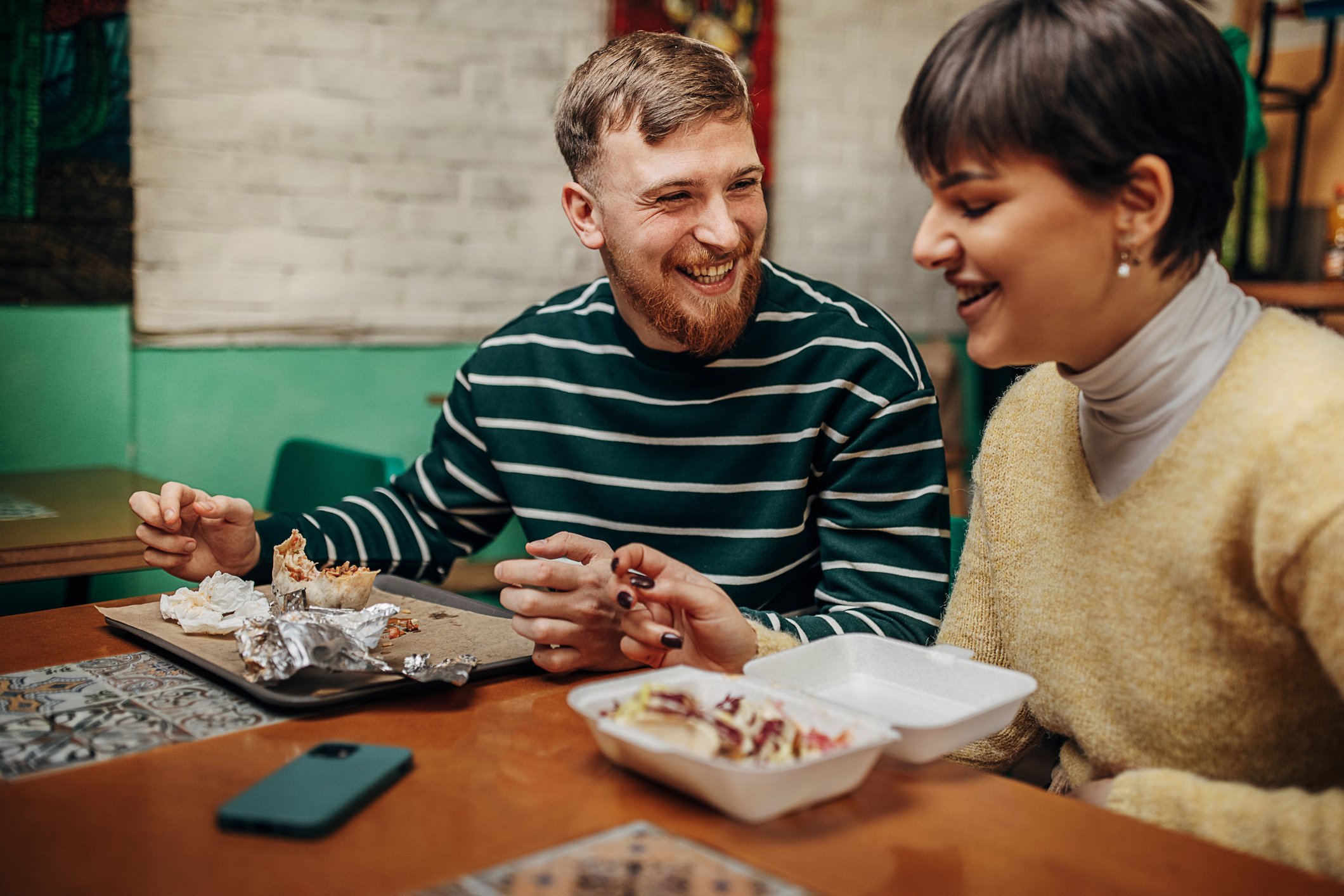 Two people eating in a restaurant.