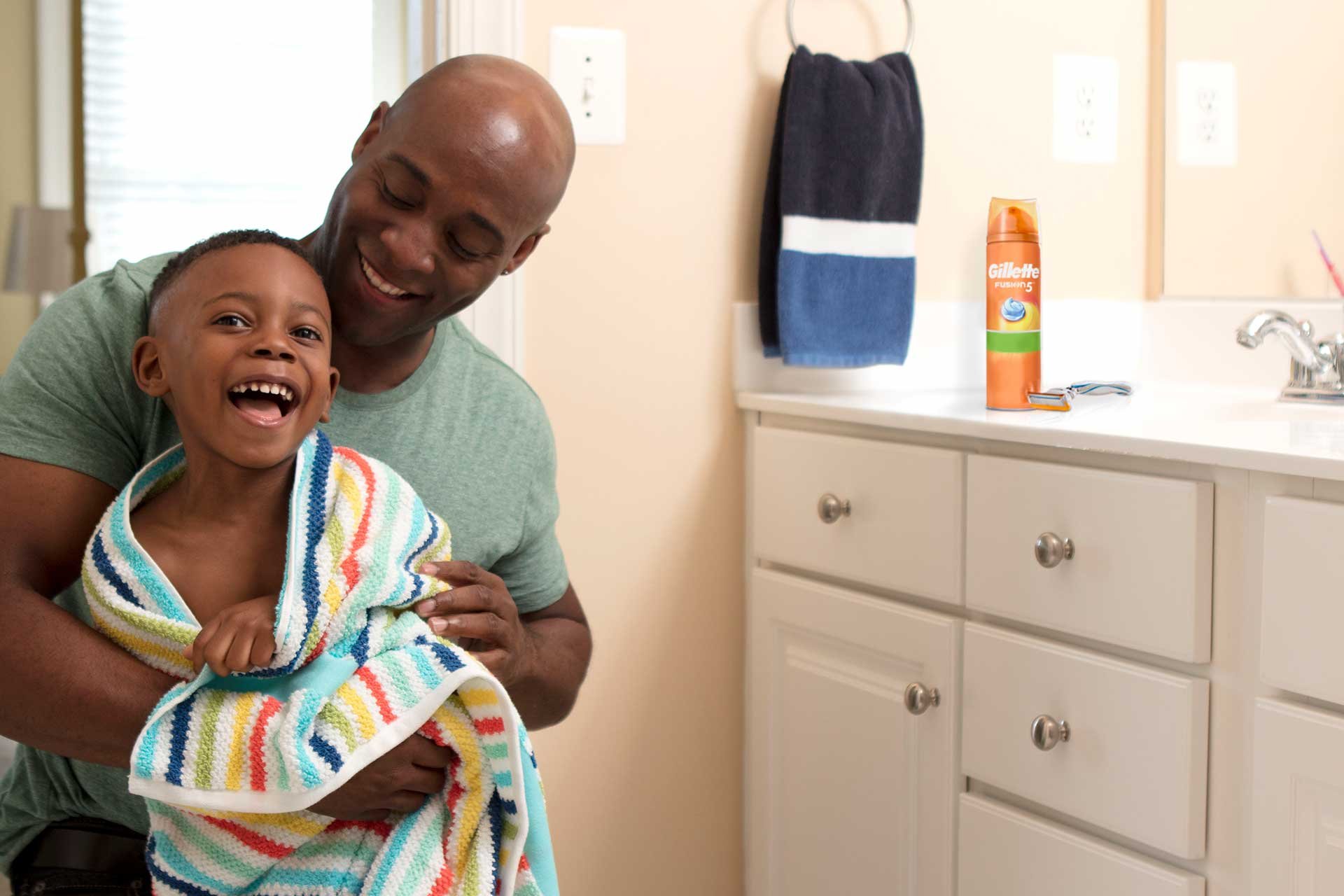 An adult and a child in a bathroom.