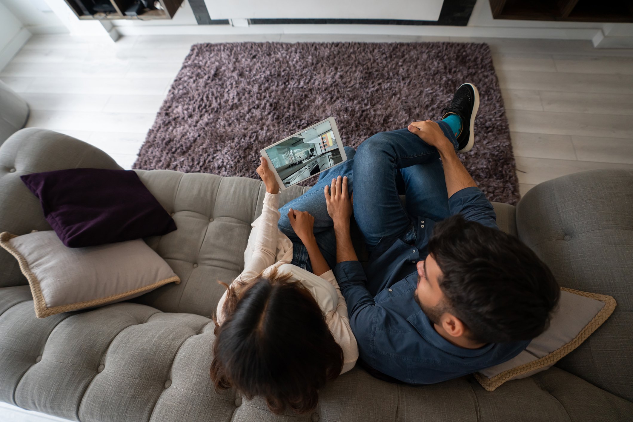 Couple taking a virtual tour of a house for sale.