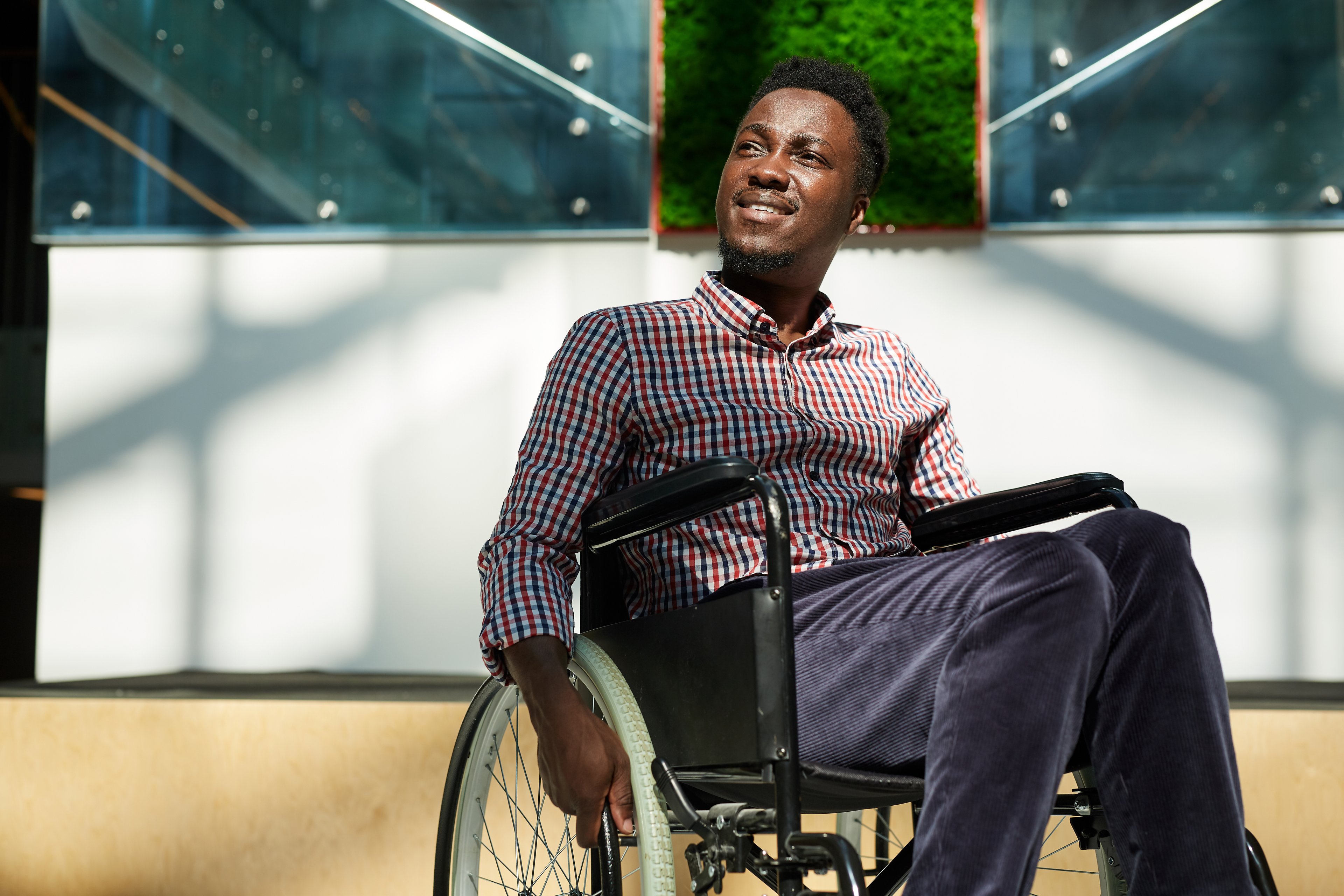 smiling person using wheelchair disability