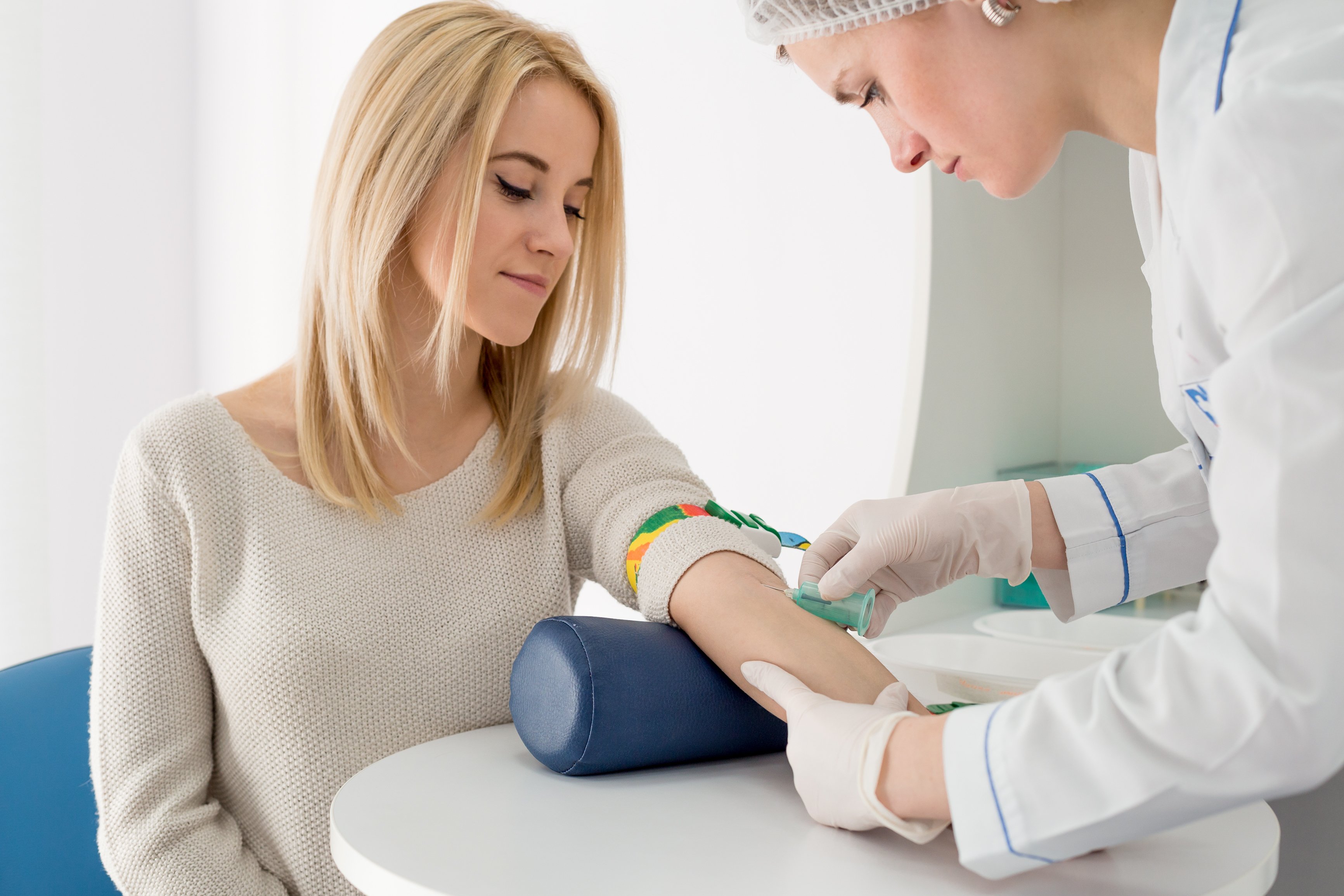 patient getting blood drawn by medical technician