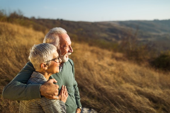 Elderly couple enjoying time together outdoors.