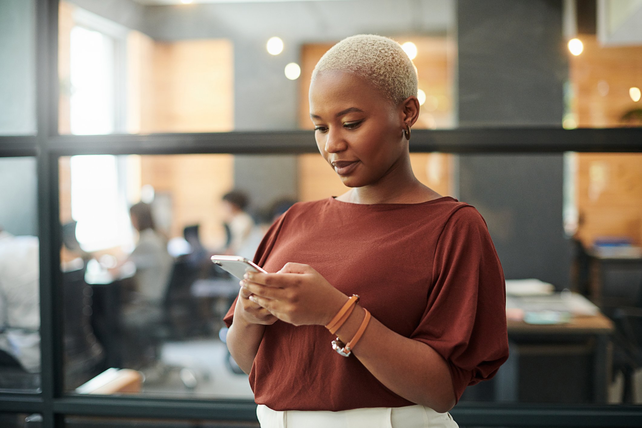 Person using their smartphone in an office.