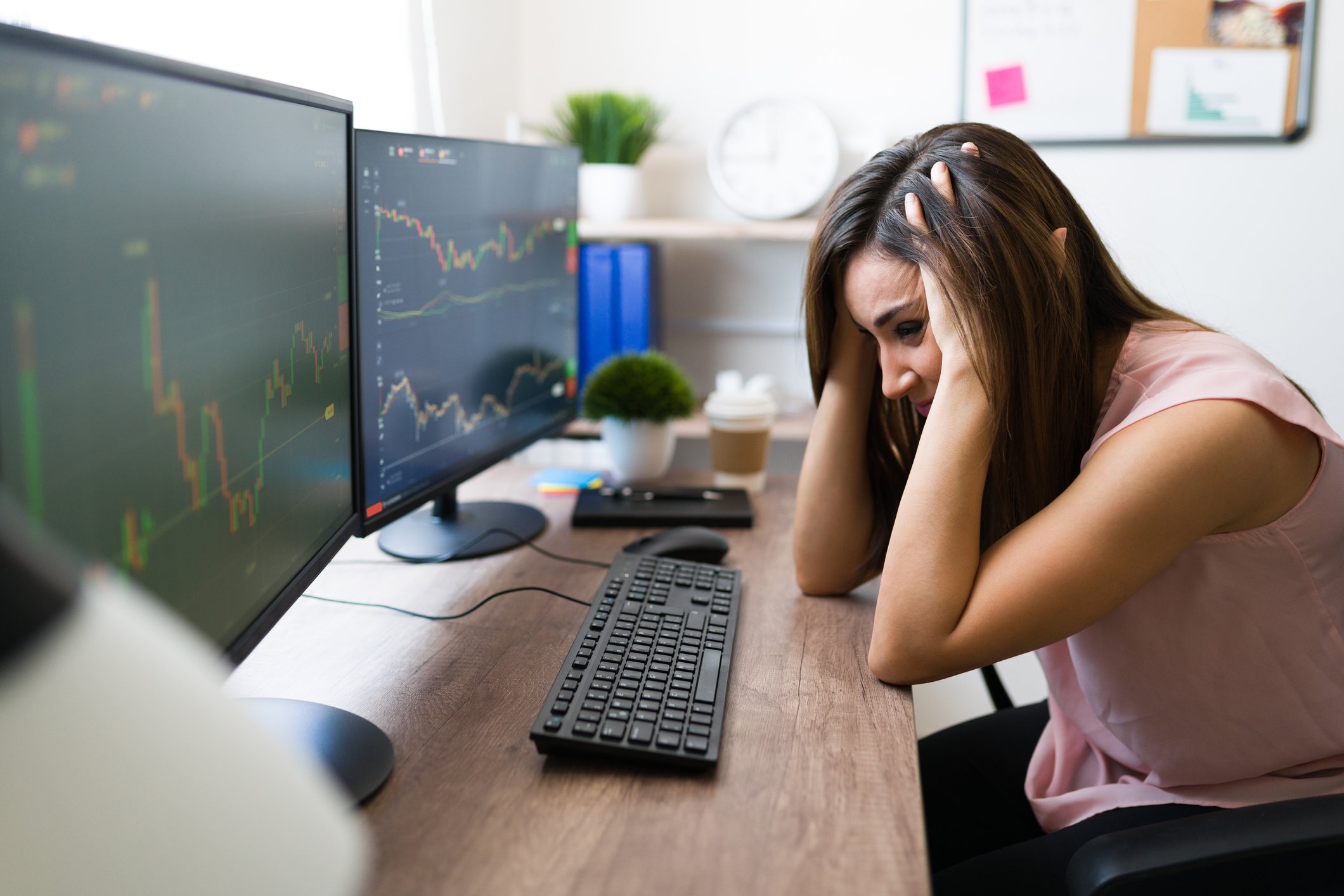 Frustrated worker looking at stock charts.