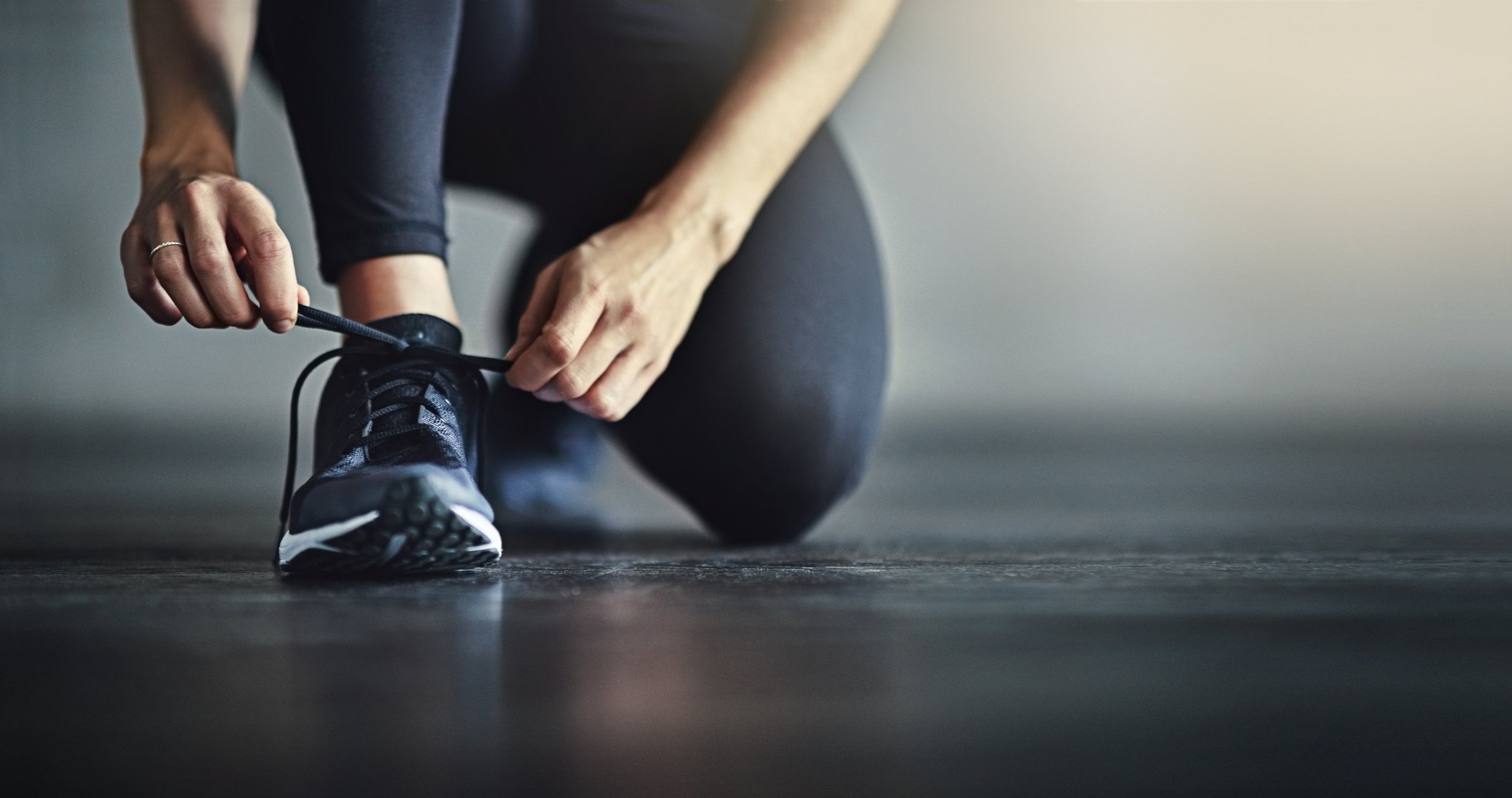 A person tying shoes before a workout.