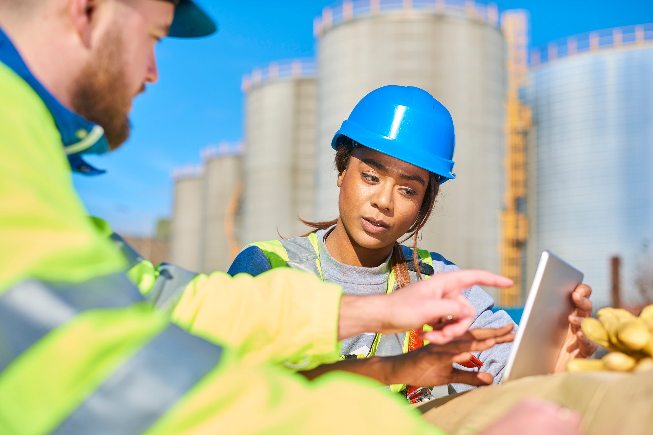 Oil and gas workers looking at a tablet computer.