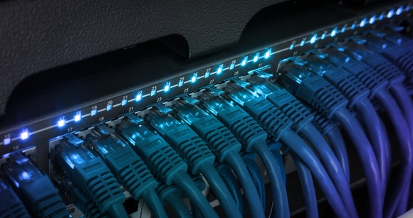 Wifi cords plugged into slots on a network switch. 