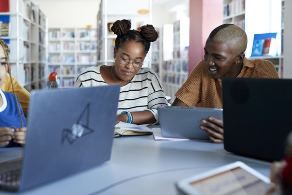 A group of people in a library.
