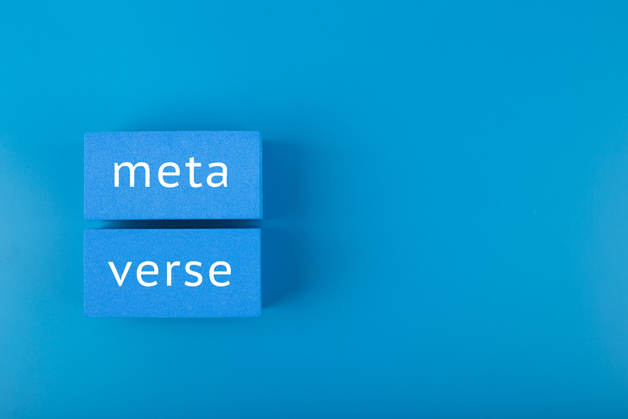 Metaverse spelled in blue blocks on a blue background. 