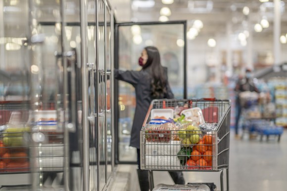 Person shopping for groceries at a warehouse store.