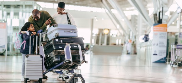 Family with luggage at airport.