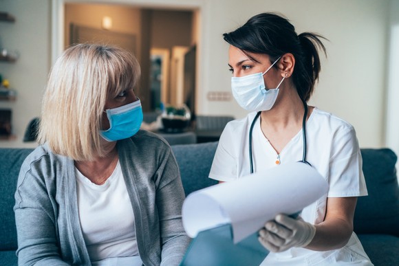 A doctor consults with a patient.