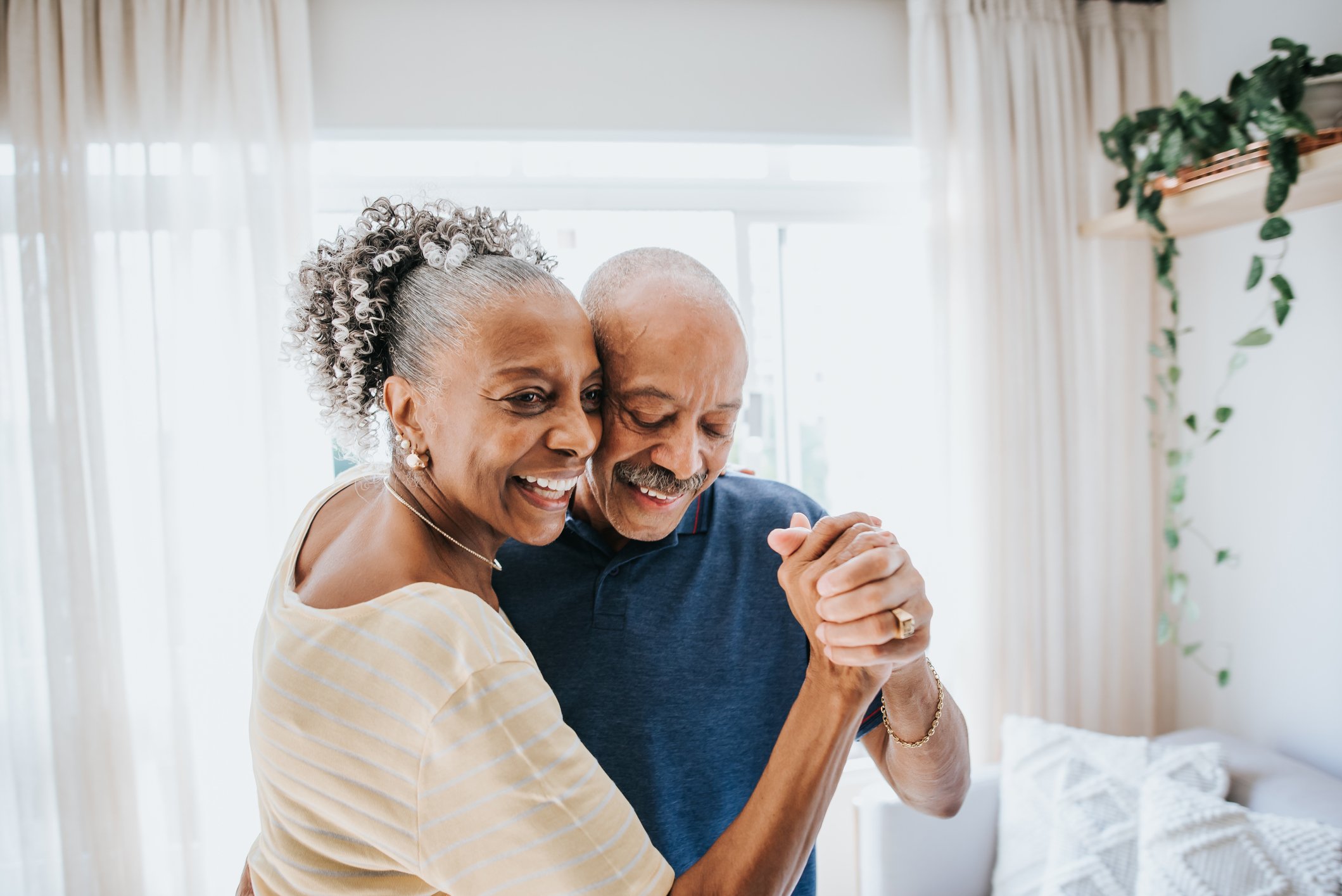 Two people dancing in a home.