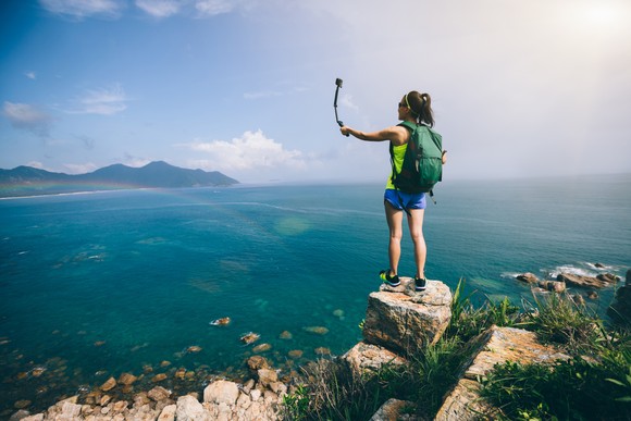 A woman standing on a rock.