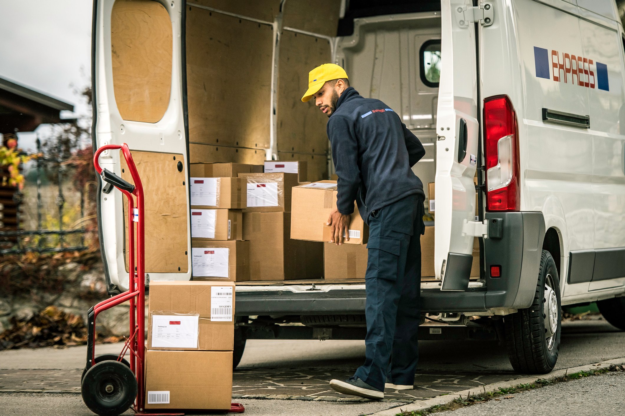 Person loading packages onto a truck.