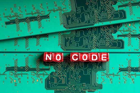The words no code spelled out in red blocks on top of a microchip.