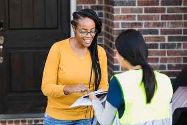 Woman Signing for Package on Digital Tablet