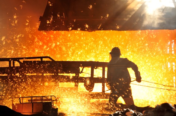 Steel worker in a fiery steel plant. 