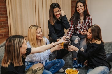 A group of women drinking cola and eating snacks