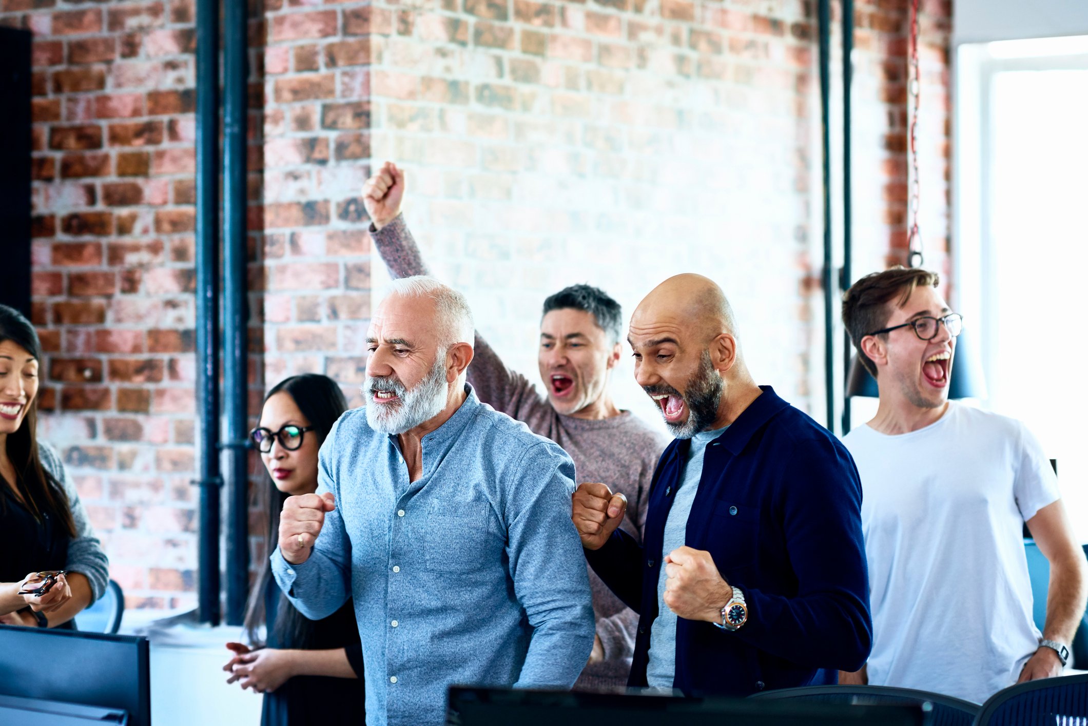 People in an office cheering.