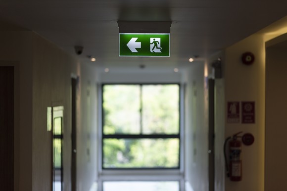 Exit sign in the hallway of a building.