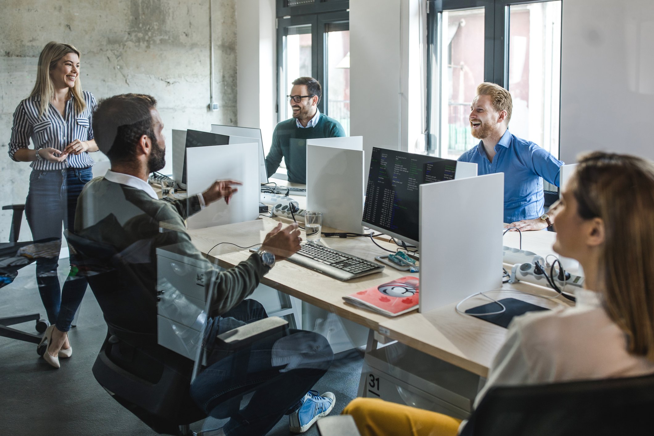 A group of software programmers work together in an office environment.