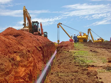 Laying a gas pipeline using machinery.