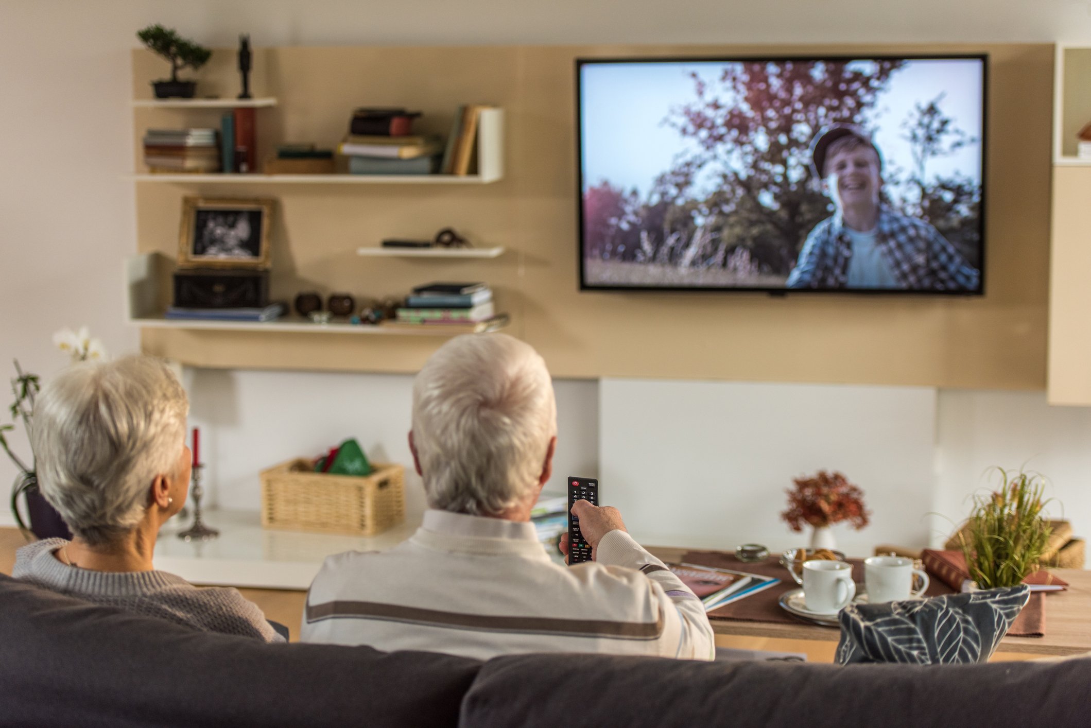 Two people watching television.