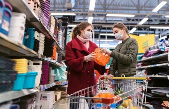 Two people shopping in a warehouse.