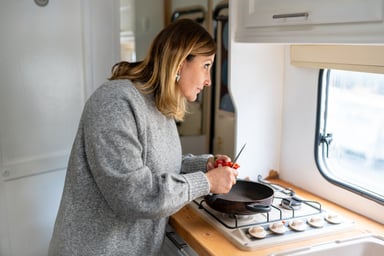 at a stove in an RV