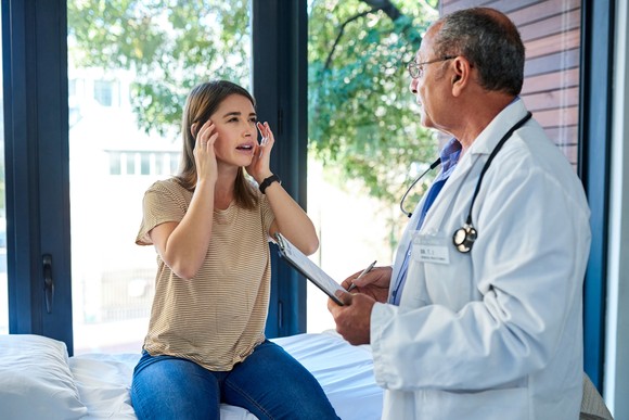 A doctor is treating a patient suffering from a migraine. 