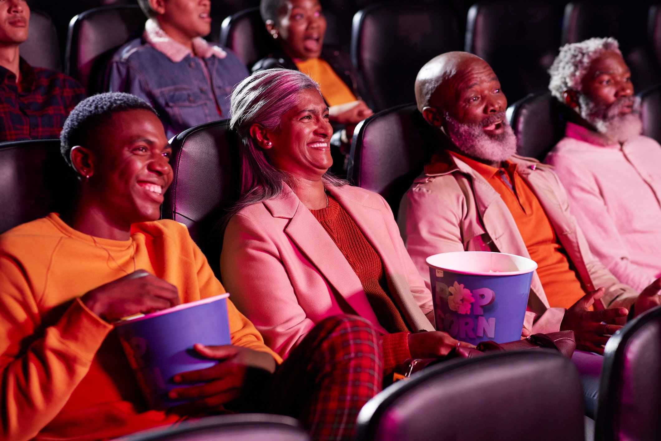 A group of people watching a movie in a movie theater.