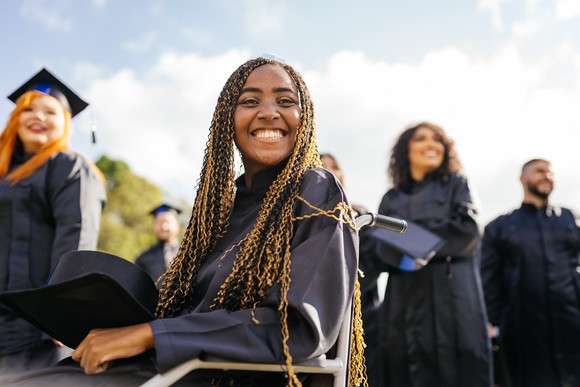 Person smiling at college graduation