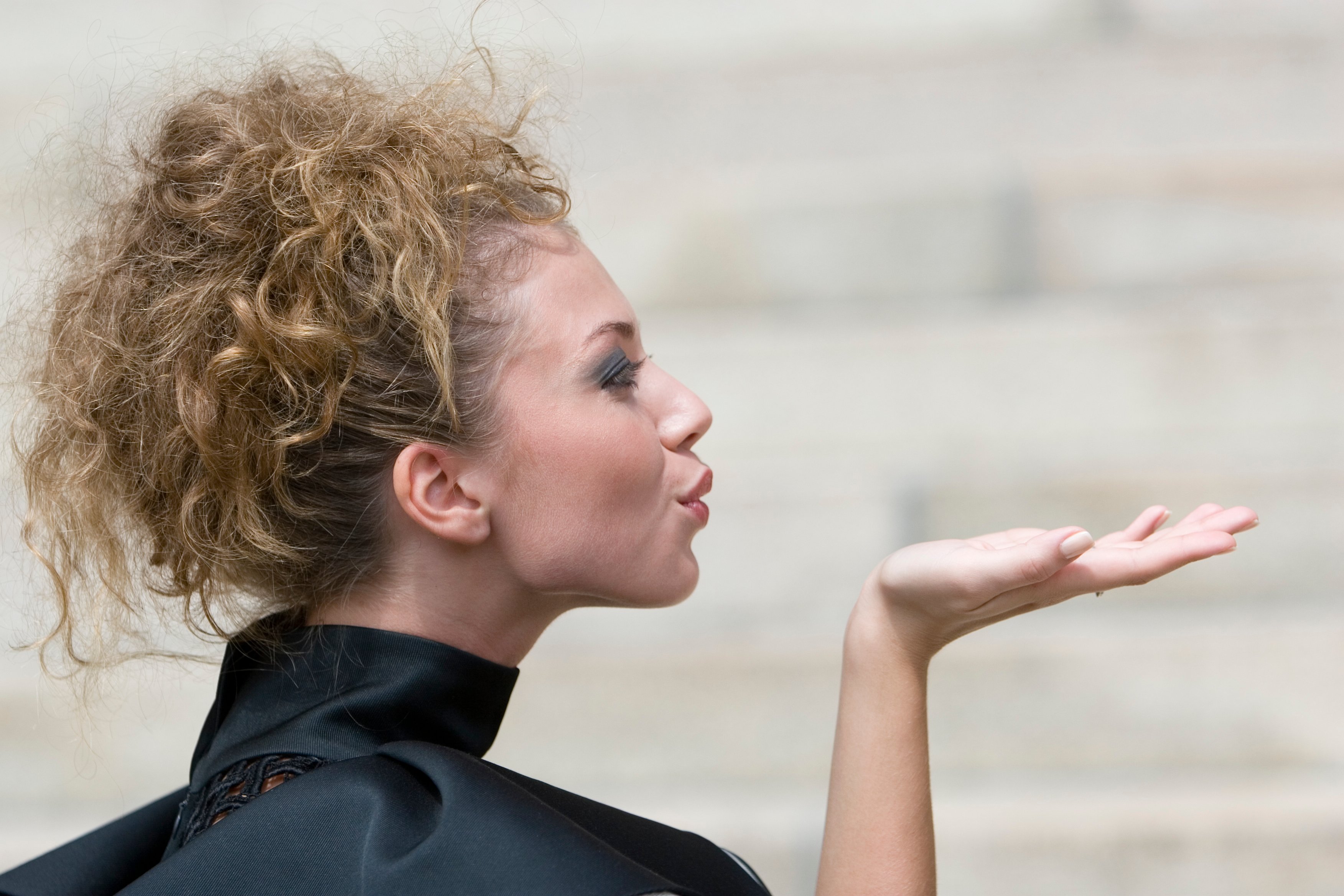 Person blowing a kiss.