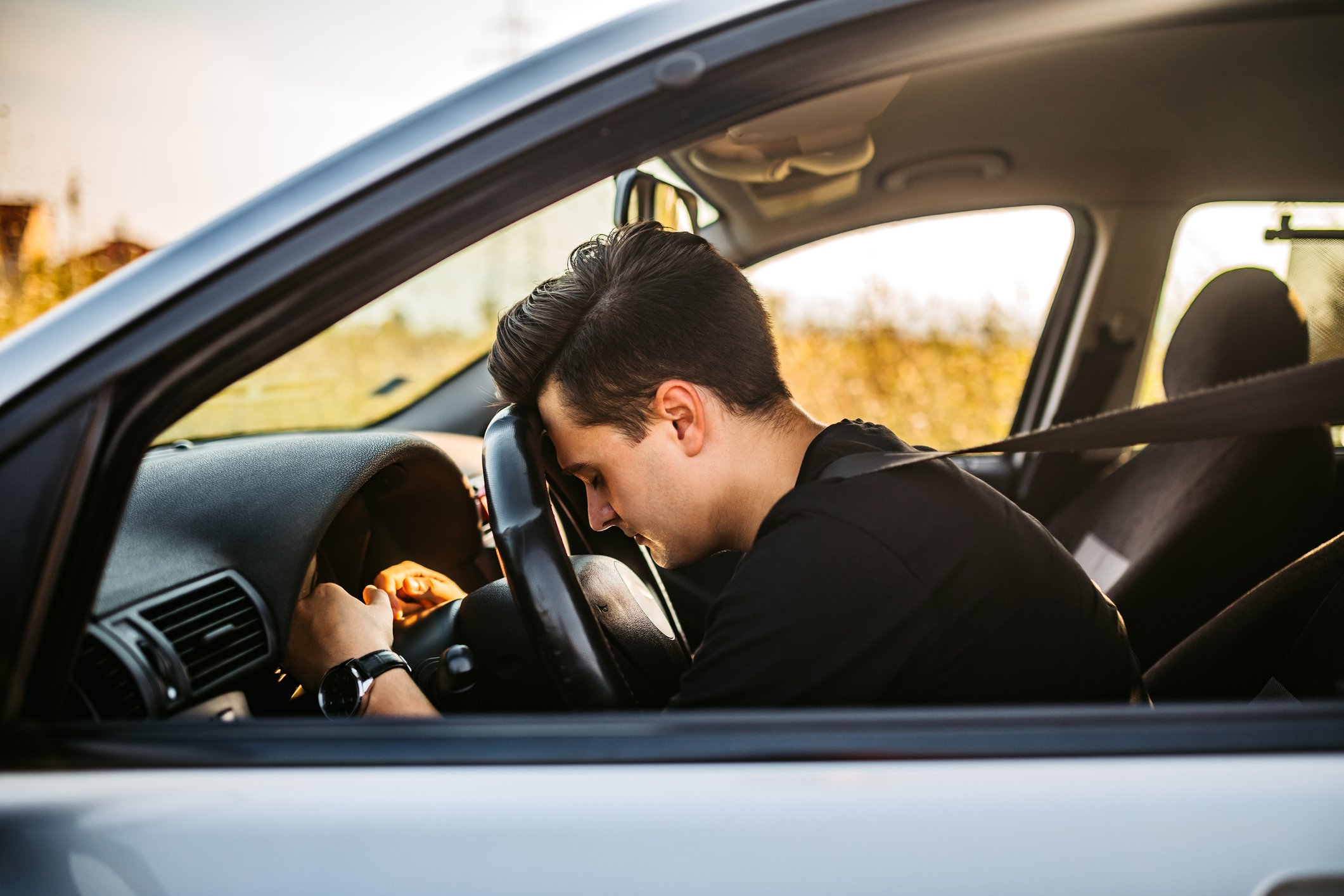 Frustrated driver with head on the steering wheel.