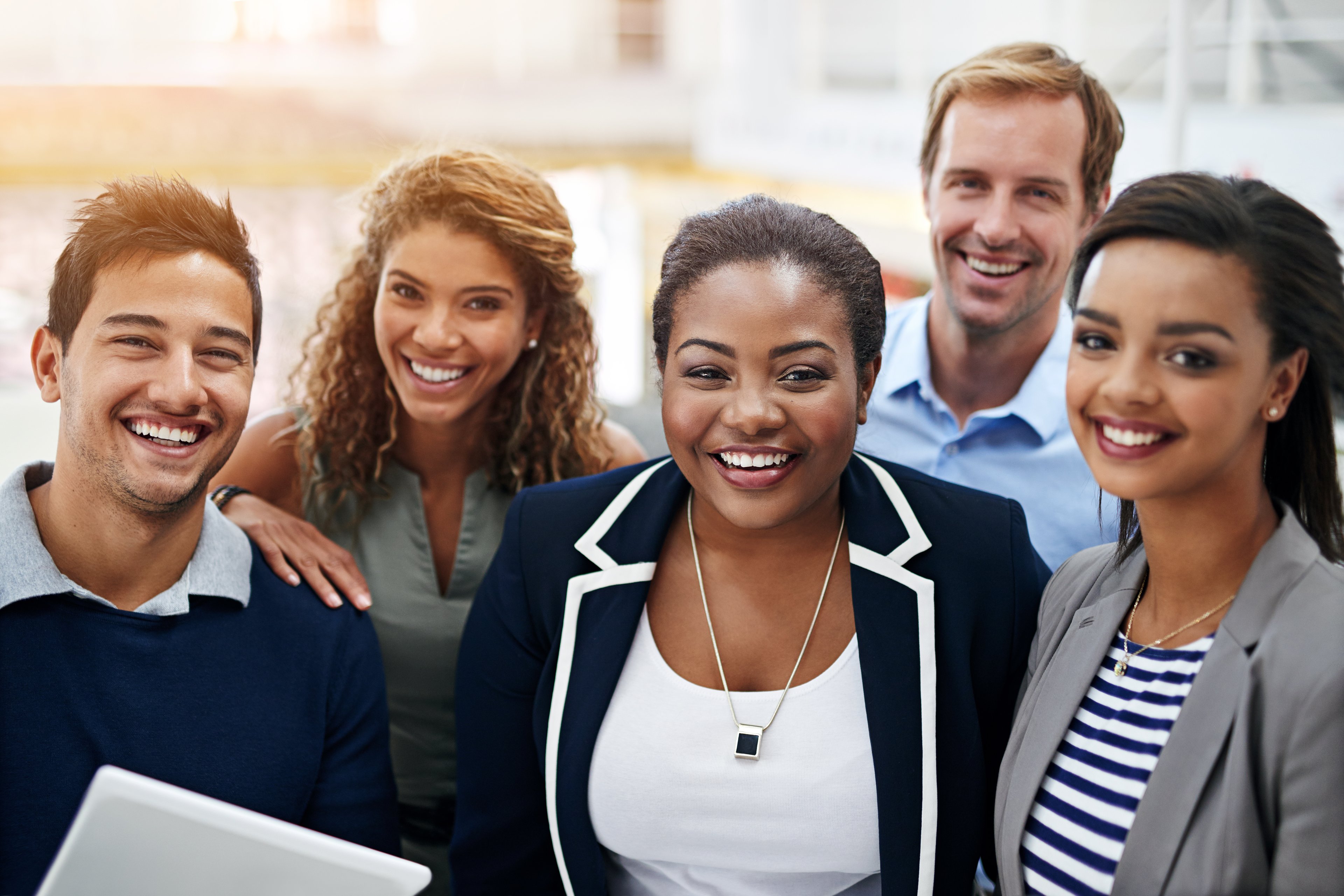 Smiling businesspeople standing in an office.