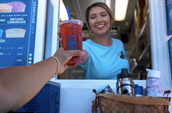 Dutch Bros. employee handing out a drink.