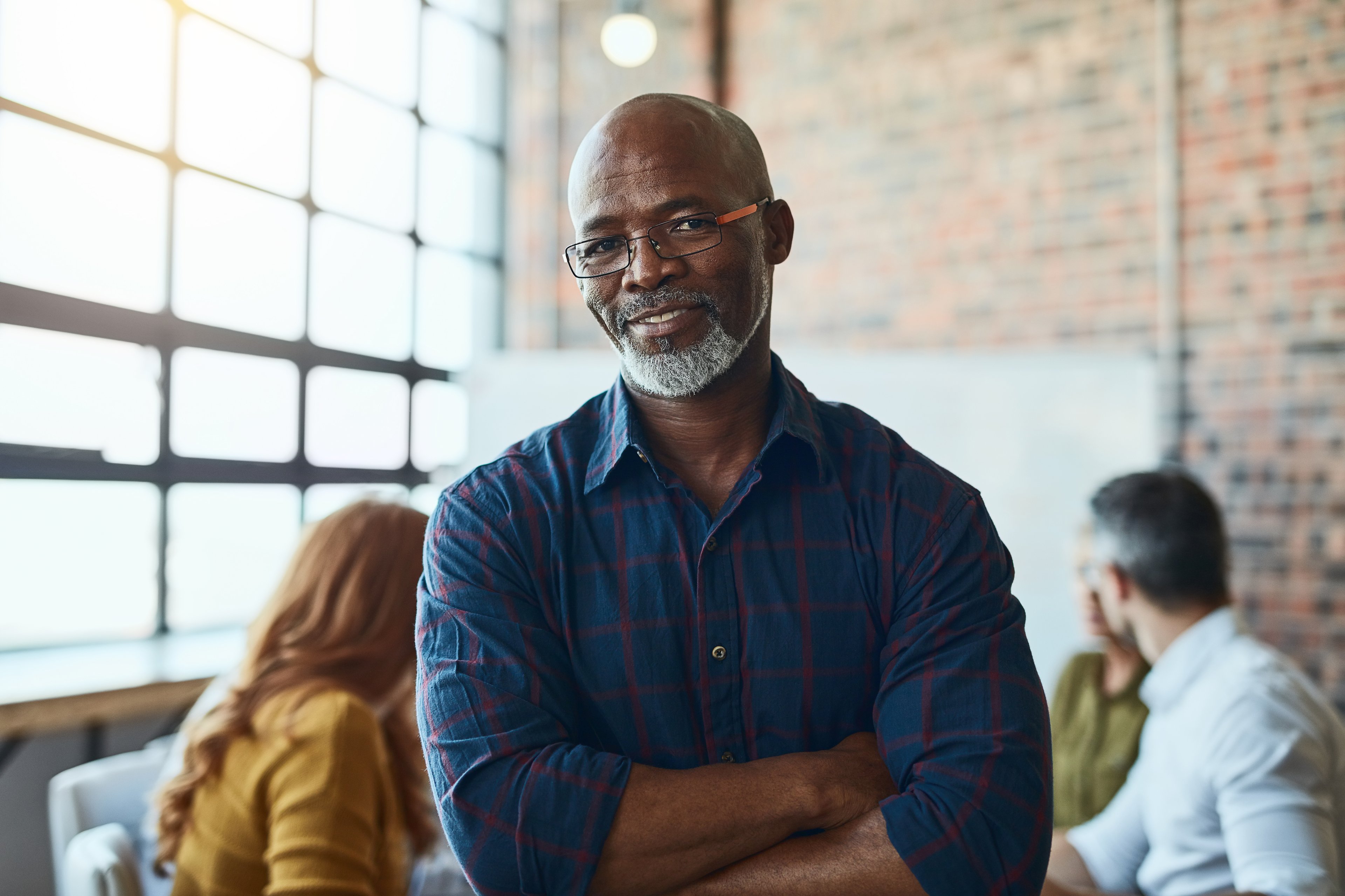A person stands with their arms folded.